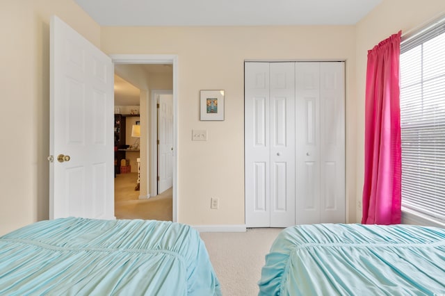 bedroom featuring carpet floors, a closet, and baseboards