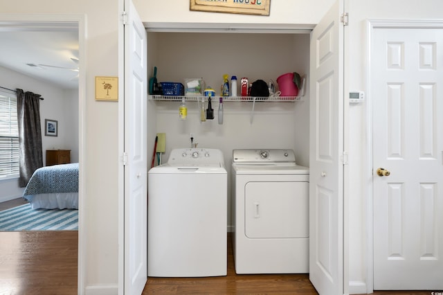 clothes washing area featuring independent washer and dryer and dark wood-style flooring