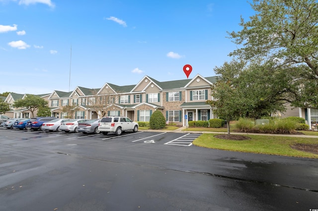 uncovered parking lot with a residential view