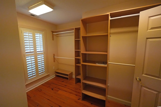 walk in closet with wood-type flooring
