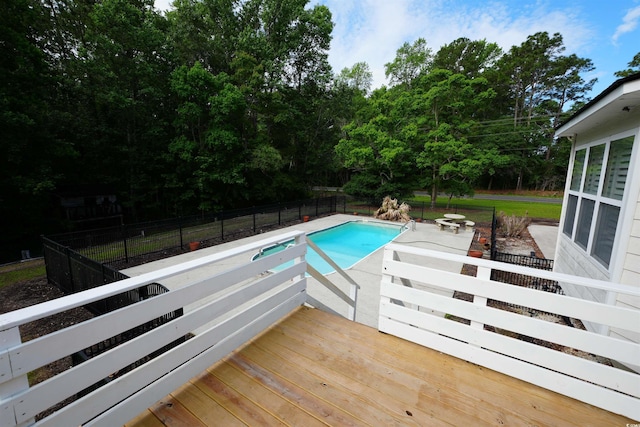view of pool featuring a deck, a fenced backyard, and a patio area