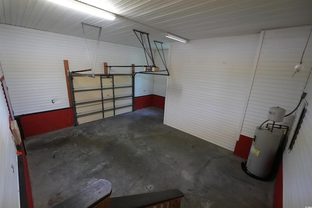 garage featuring electric water heater and a garage door opener