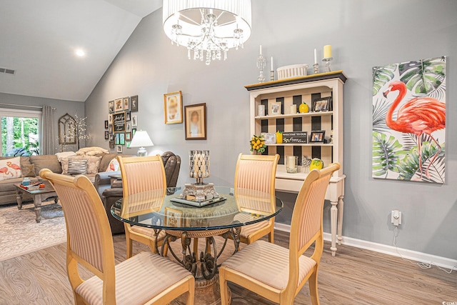 2016 Willow Run Dr Unit B, Little River, SC 29566 - dining area featuring light wood-style flooring, high vaulted ceiling, a chandelier, and baseboards