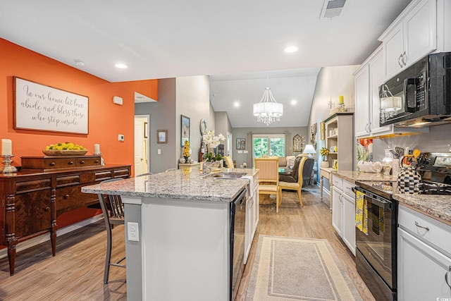 2016 Willow Run Dr Unit B, Little River, SC 29566 - kitchen with black appliances, light wood-type flooring, a center island with sink, white cabinets, and a chandelier