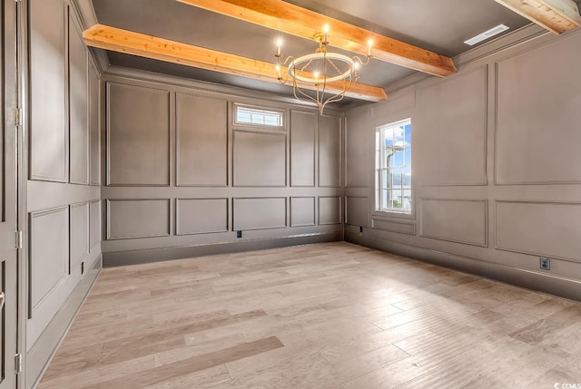 441 Saint Julian Ln, Myrtle Beach, SC 29579 - empty room featuring a decorative wall, a chandelier, beamed ceiling, plenty of natural light, and light wood-style flooring
