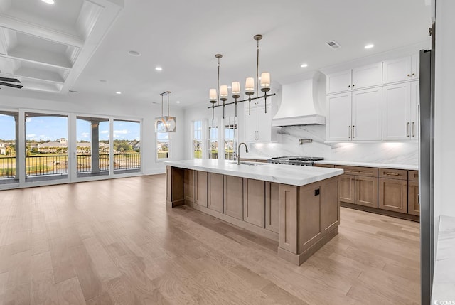 441 Saint Julian Ln, Myrtle Beach, SC 29579 - kitchen with custom range hood, a sink, a chandelier, recessed lighting, and tasteful backsplash