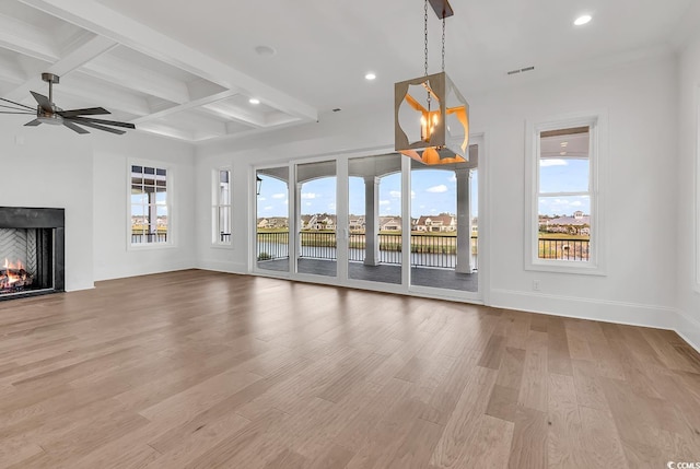 441 Saint Julian Ln, Myrtle Beach, SC 29579 - unfurnished living room featuring beam ceiling, a ceiling fan, coffered ceiling, healthy amount of natural light, and a warm lit fireplace