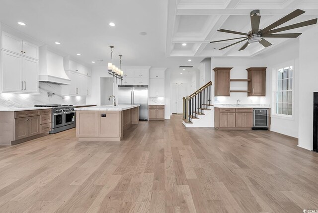 441 Saint Julian Ln, Myrtle Beach, SC 29579 - kitchen featuring premium appliances, custom exhaust hood, wine cooler, a ceiling fan, and light countertops