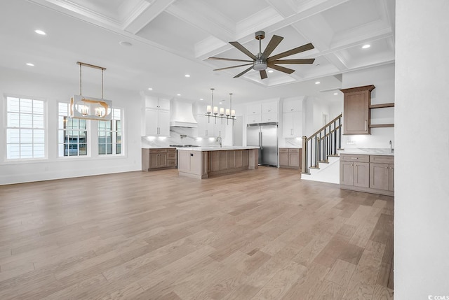 441 Saint Julian Ln, Myrtle Beach, SC 29579 - unfurnished living room featuring a chandelier, a ceiling fan, recessed lighting, beamed ceiling, and light wood-style floors