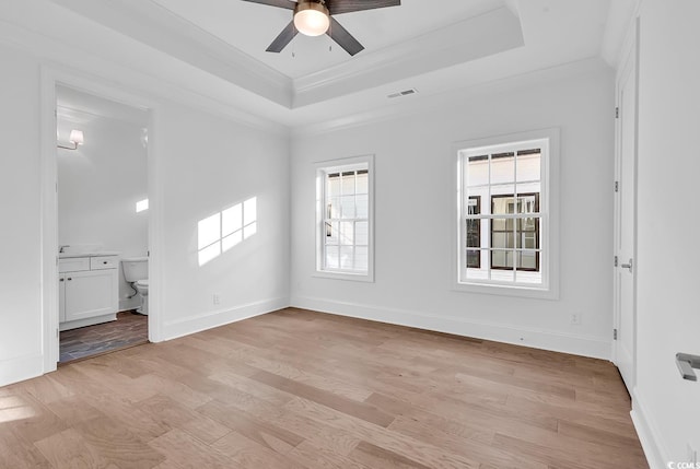441 Saint Julian Ln, Myrtle Beach, SC 29579 - unfurnished room featuring a tray ceiling, a ceiling fan, ornamental molding, light wood-style flooring, and baseboards
