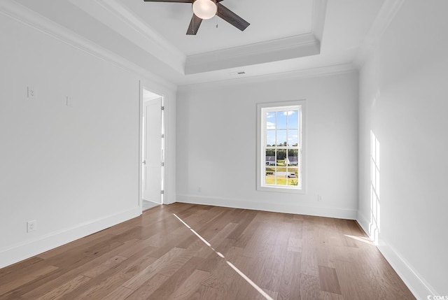 441 Saint Julian Ln, Myrtle Beach, SC 29579 - spare room featuring crown molding, a tray ceiling, a ceiling fan, wood finished floors, and baseboards