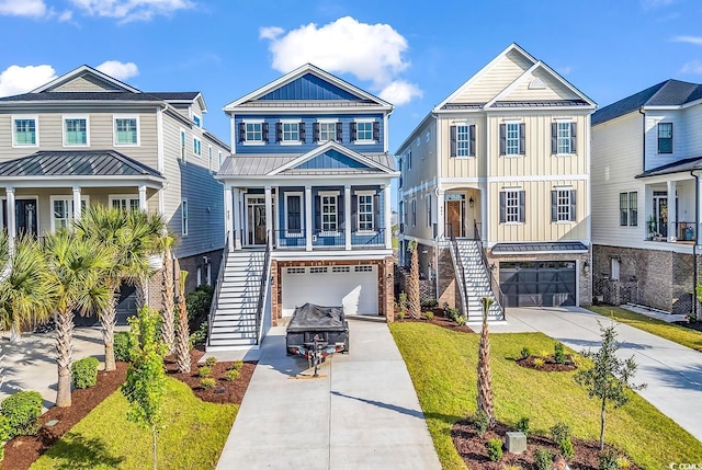437 Saint Julian Ln, Myrtle Beach, SC 29579 - coastal home featuring stairway, a garage, concrete driveway, and board and batten siding