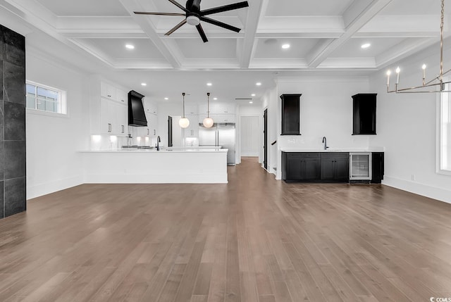 437 Saint Julian Ln, Myrtle Beach, SC 29579 - unfurnished living room featuring beverage cooler, wood finished floors, beamed ceiling, recessed lighting, and a ceiling fan