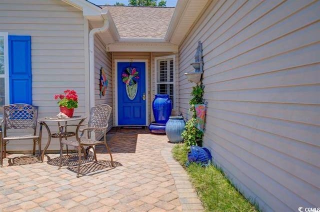 901 Southwind Ct, Garden City Beach, SC 29576 - doorway to property with a patio area and a shingled roof