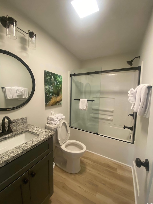 6205 Nixon St, North Myrtle Beach, SC 29582 - bathroom featuring wood finished floors, vanity, combined bath / shower with glass door, and toilet