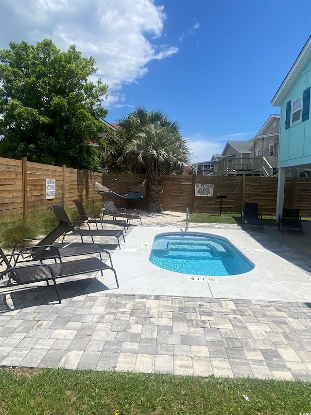 6205 Nixon St, North Myrtle Beach, SC 29582 - view of pool featuring fence, a patio area, and a jacuzzi