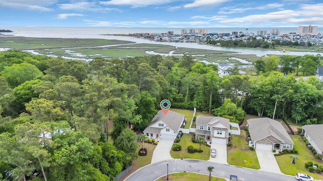 aerial view of property's location featuring a large body of water and nearby urban area