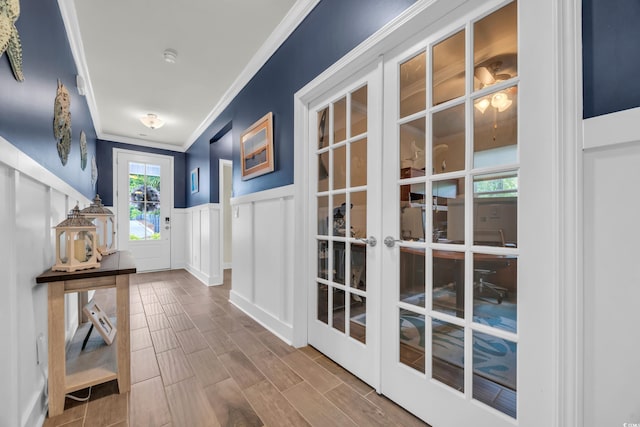 1009 Oak Marsh Ln, North Myrtle Beach, SC 29582 - doorway featuring ornamental molding, a decorative wall, wainscoting, french doors, and wood finished floors