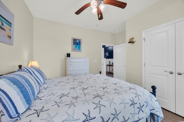 bedroom featuring a closet, wood finished floors, and ceiling fan