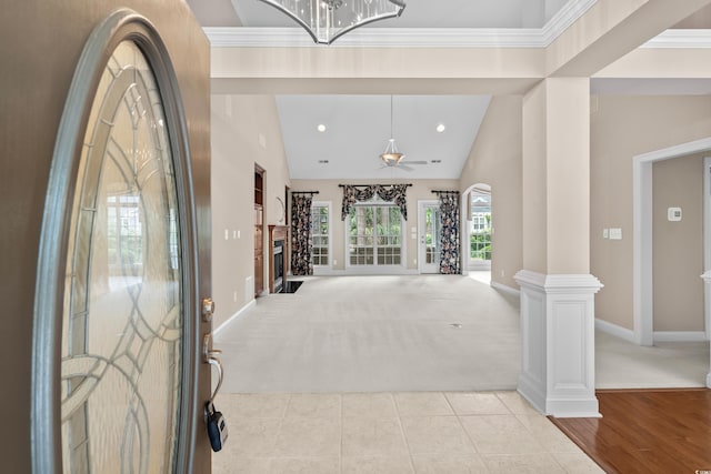 entryway with light colored carpet, baseboards, lofted ceiling, a chandelier, and recessed lighting