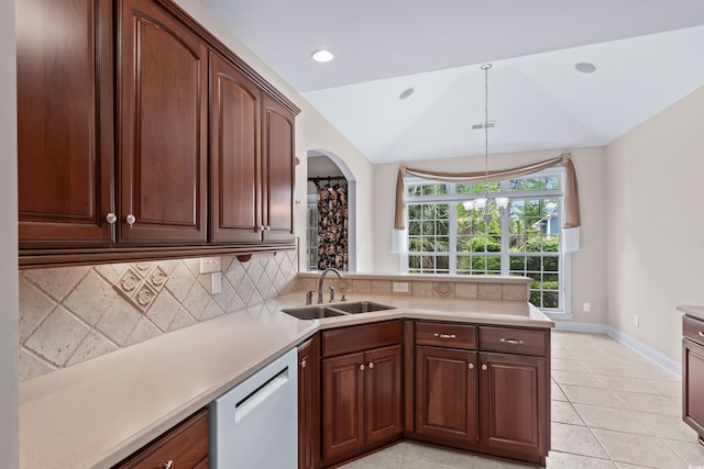 kitchen featuring a sink, dishwasher, vaulted ceiling, tasteful backsplash, and light countertops