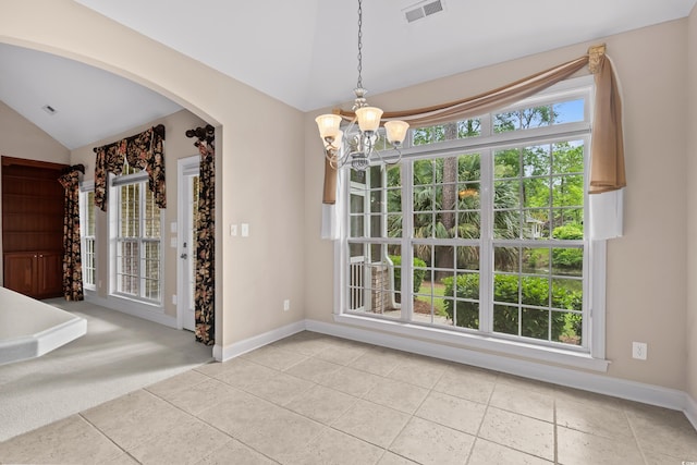 unfurnished dining area featuring vaulted ceiling, a chandelier, arched walkways, light tile patterned floors, and baseboards