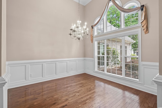 1315 Cherry Dr, Surfside Beach, SC 29575 - unfurnished dining area with a wainscoted wall, a chandelier, wood finished floors, and a decorative wall