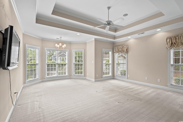 empty room featuring light colored carpet, a tray ceiling, baseboards, a chandelier, and ornamental molding