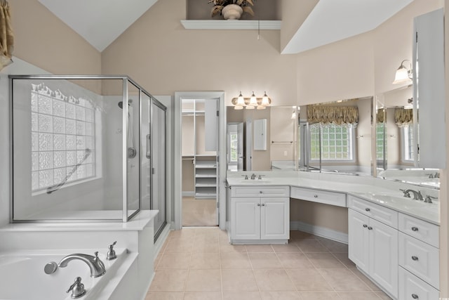 full bathroom featuring tile patterned flooring, a stall shower, vanity, a bath, and high vaulted ceiling