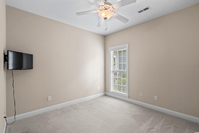 unfurnished room featuring baseboards, carpet floors, and a ceiling fan