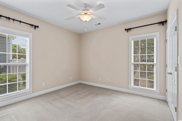 unfurnished room featuring light carpet, baseboards, and ceiling fan
