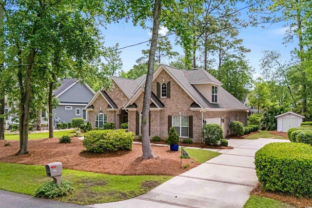 traditional-style house featuring brick siding, a shed, concrete driveway, an outdoor structure, and a shingled roof