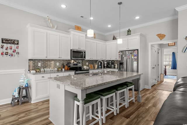 322 Canyon Dr, Conway, SC 29526 - kitchen with stainless steel appliances, a sink, tasteful backsplash, white cabinets, and crown molding