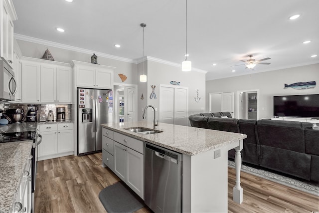 322 Canyon Dr, Conway, SC 29526 - kitchen with stainless steel appliances, a sink, open floor plan, light wood-type flooring, and crown molding