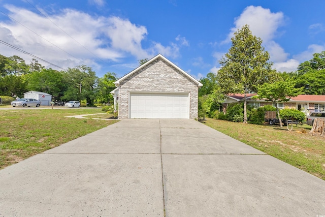 view of front of property featuring a garage, a front yard, brick siding, and driveway