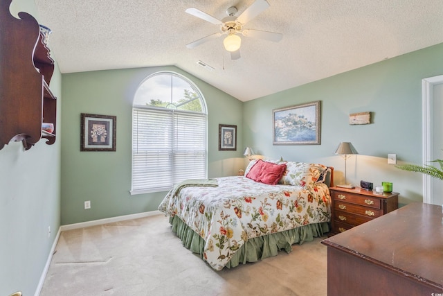 bedroom featuring carpet flooring, lofted ceiling, a ceiling fan, a textured ceiling, and baseboards