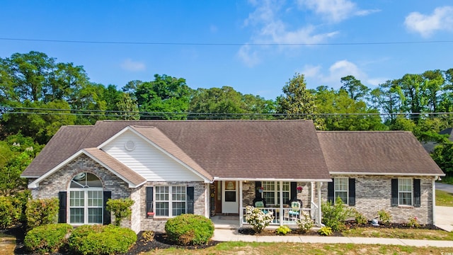 view of front of home with covered porch and brick siding