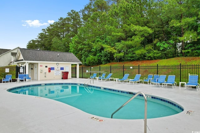 community pool featuring a patio and fence