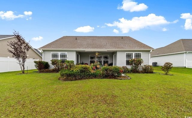 rear view of property featuring central AC and roof with shingles