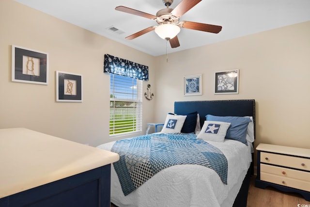 bedroom with wood finished floors and a ceiling fan