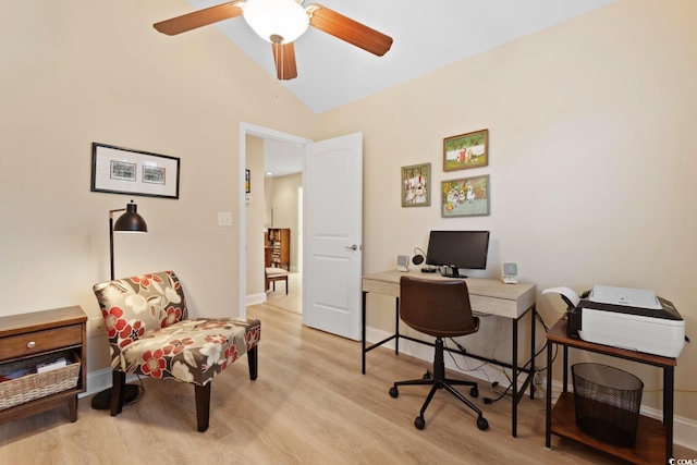 home office featuring light wood-type flooring, vaulted ceiling, a ceiling fan, and baseboards