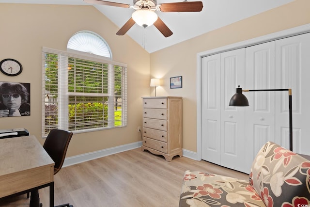 office featuring a ceiling fan, light wood finished floors, baseboards, and high vaulted ceiling
