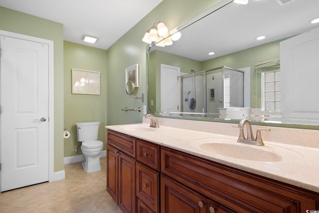 full bath with a stall shower, tile patterned floors, toilet, double vanity, and baseboards