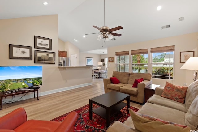 living area with a ceiling fan, light wood-type flooring, baseboards, recessed lighting, and high vaulted ceiling
