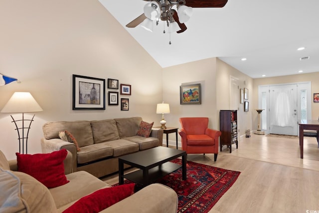 living room with ceiling fan, recessed lighting, baseboards, light wood-style floors, and high vaulted ceiling