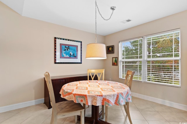 dining space featuring baseboards and light tile patterned floors
