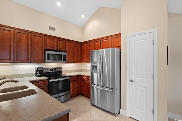 kitchen featuring appliances with stainless steel finishes, light tile patterned floors, high vaulted ceiling, a sink, and light countertops