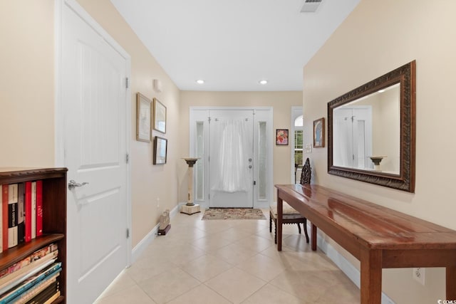entrance foyer with baseboards, light tile patterned floors, and recessed lighting