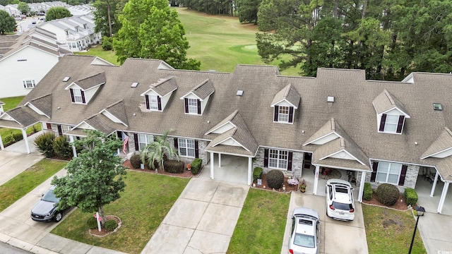 aerial view of property and surrounding area with a local golf course