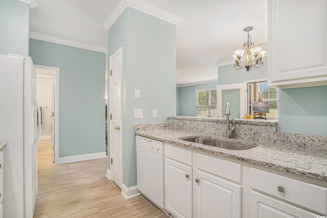 kitchen featuring white appliances, a sink, ornamental molding, a chandelier, and white cabinets